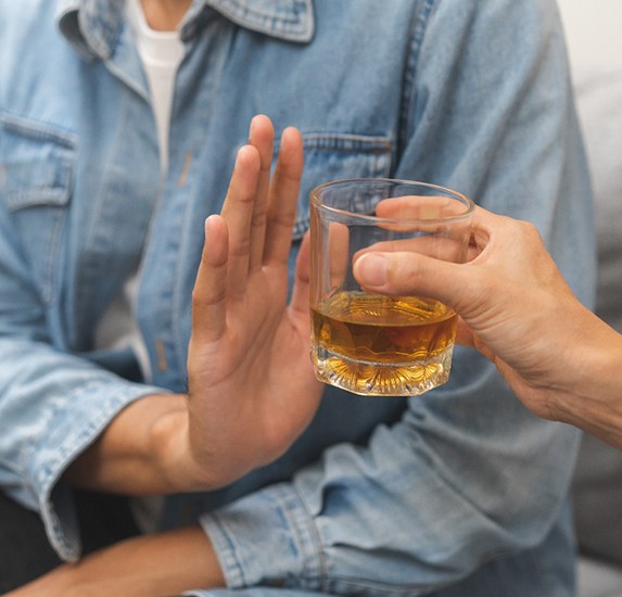 A young man refusing an alcoholic drink