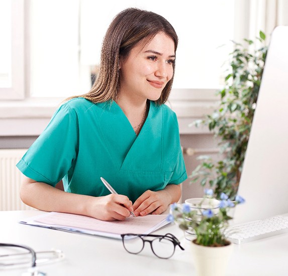 A medical professional working at her computer