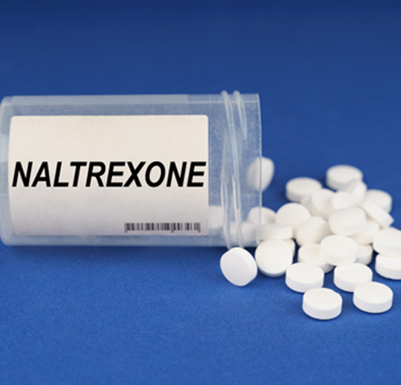 A tipped-over pill bottle labelled ‘Naltrexone’