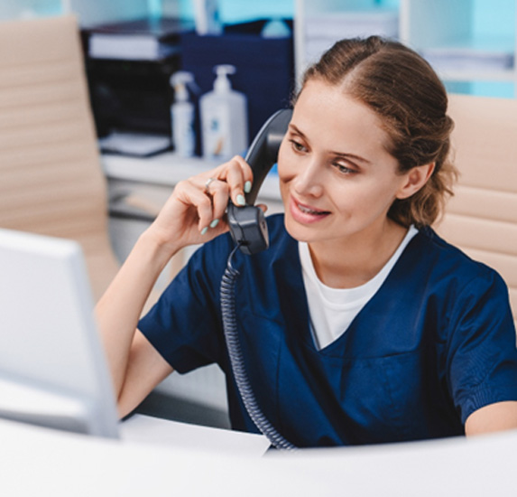 A young receptionist talking on the phone
