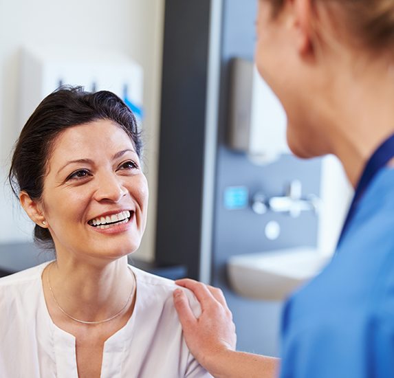 A female patient being reassured by her doctor